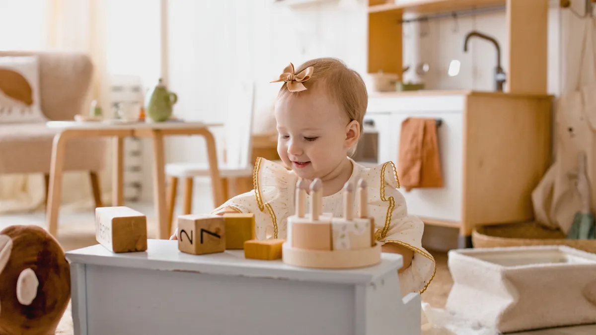 Toddler playing with a wooden activity toy indoors