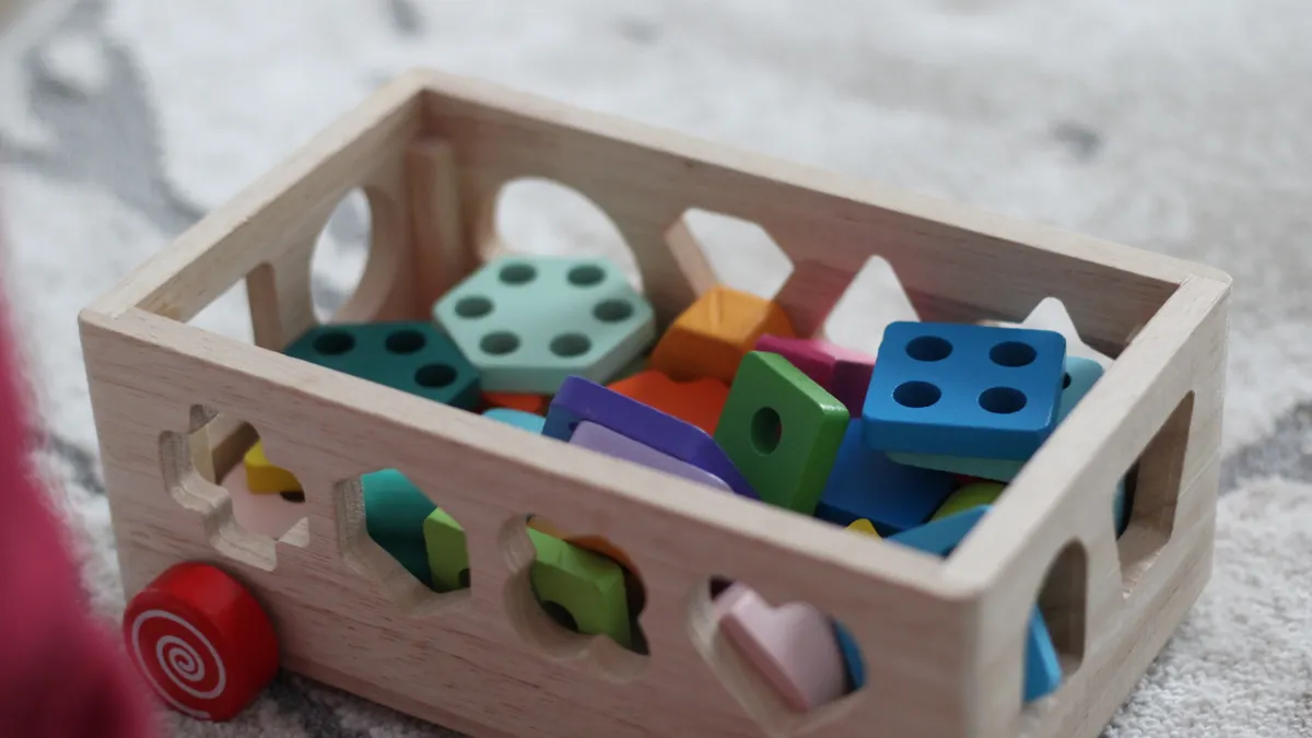 How to Choose Safe Sensory Toys for Toddlers Wooden box of colorful toddler blocks